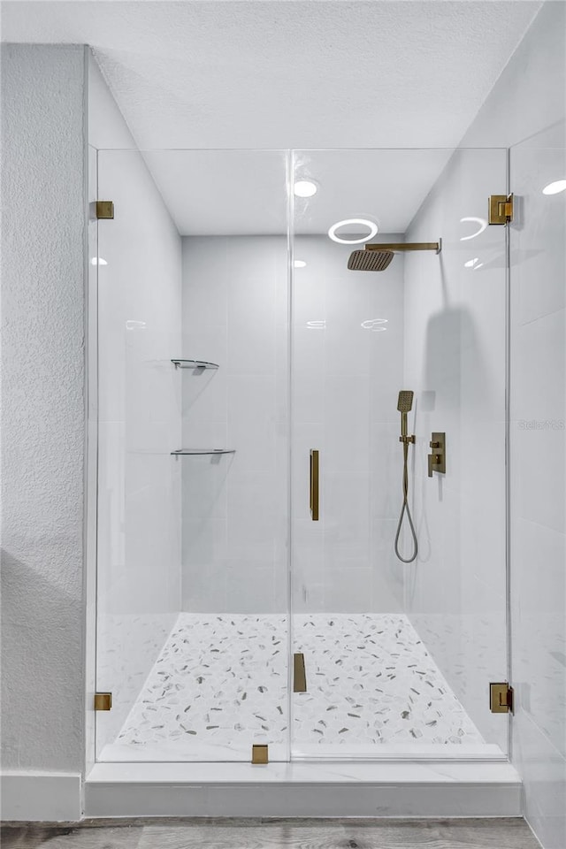 bathroom featuring a shower with door