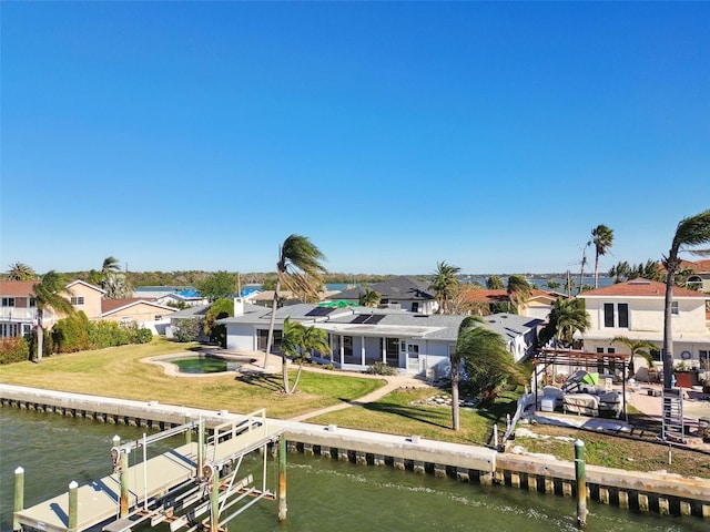 back of property featuring a lawn and a water view