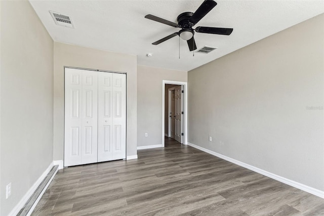 102 Shore Dr E, Oldsmar, FL 34677 - unfurnished bedroom with wood finished floors, a closet, and ceiling fan