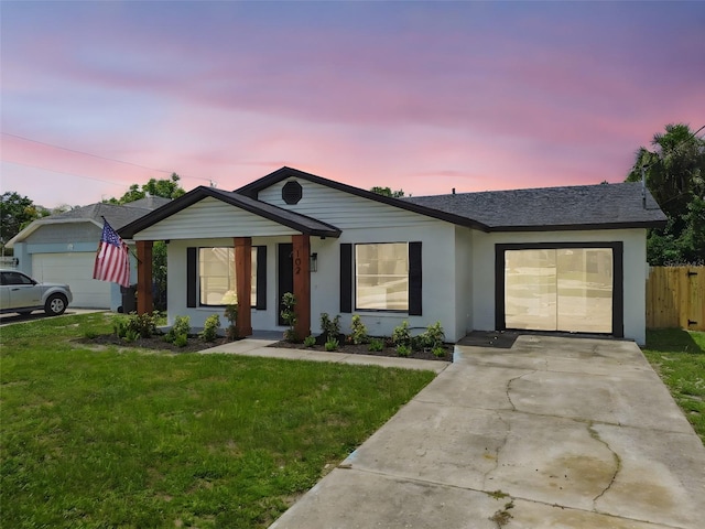 102 Shore Dr E, Oldsmar, FL 34677 - single story home featuring stucco siding, a garage, concrete driveway, and a shingled roof