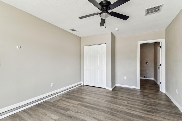 102 Shore Dr E, Oldsmar, FL 34677 - unfurnished bedroom featuring wood finished floors, a closet, and a ceiling fan
