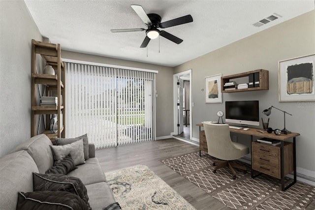 102 Shore Dr E, Oldsmar, FL 34677 - office area featuring wood finished floors, ceiling fan, and a textured ceiling
