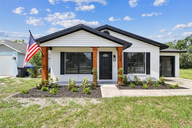 102 Shore Dr E, Oldsmar, FL 34677 - view of front of property with a front lawn and stucco siding