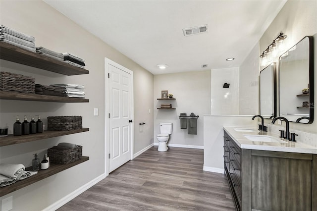 102 Shore Dr E, Oldsmar, FL 34677 - full bathroom featuring double vanity, wood finished floors, and recessed lighting
