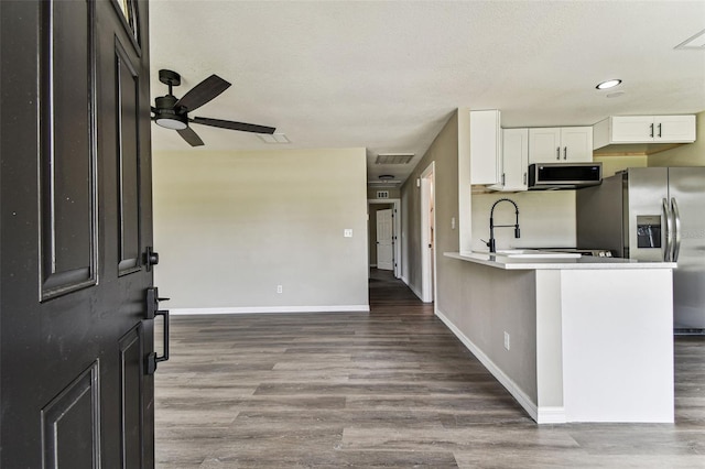 102 Shore Dr E, Oldsmar, FL 34677 - kitchen with stainless steel appliances, white cabinetry, wood finished floors, ceiling fan, and recessed lighting