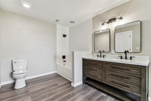 102 Shore Dr E, Oldsmar, FL 34677 - full bath featuring double vanity, wood finished floors, and bathtub / shower combination