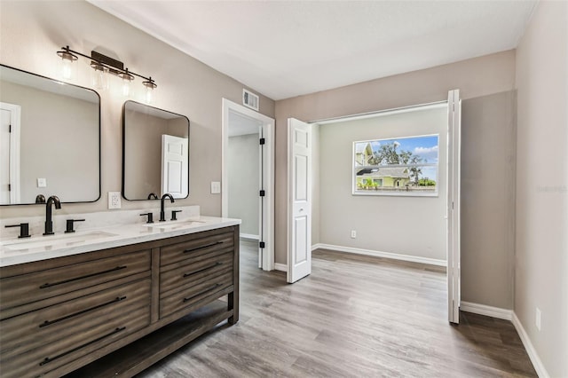 102 Shore Dr E, Oldsmar, FL 34677 - bathroom with double vanity and wood finished floors