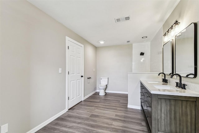 102 Shore Dr E, Oldsmar, FL 34677 - bathroom featuring double vanity and wood finished floors