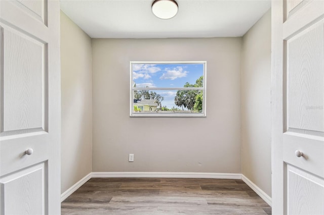 102 Shore Dr E, Oldsmar, FL 34677 - empty room with wood finished floors and baseboards