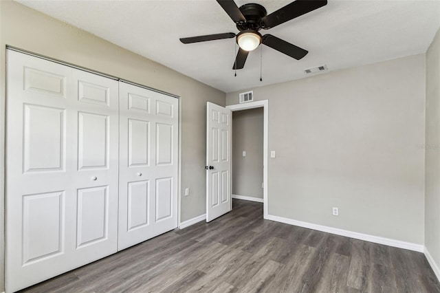 102 Shore Dr E, Oldsmar, FL 34677 - unfurnished bedroom featuring wood finished floors, a closet, and ceiling fan