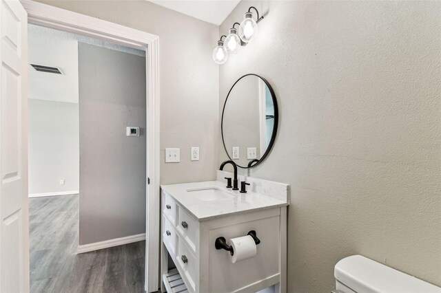 102 Shore Dr E, Oldsmar, FL 34677 - half bathroom with wood finished floors and vanity