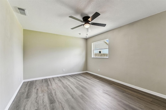 102 Shore Dr E, Oldsmar, FL 34677 - spare room featuring wood finished floors, a ceiling fan, and a textured ceiling