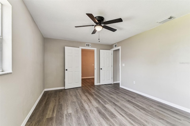 102 Shore Dr E, Oldsmar, FL 34677 - unfurnished bedroom featuring wood finished floors and a ceiling fan