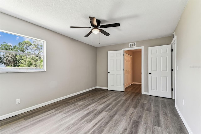102 Shore Dr E, Oldsmar, FL 34677 - unfurnished bedroom featuring wood finished floors and ceiling fan