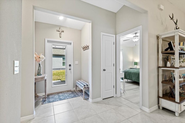 tiled foyer with ceiling fan