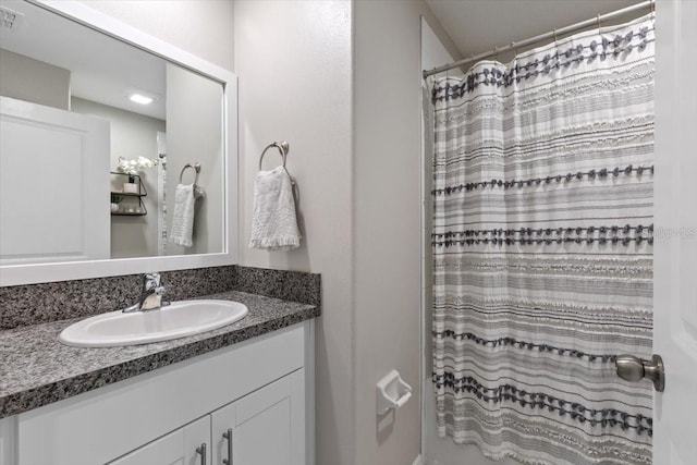 bathroom featuring vanity and curtained shower