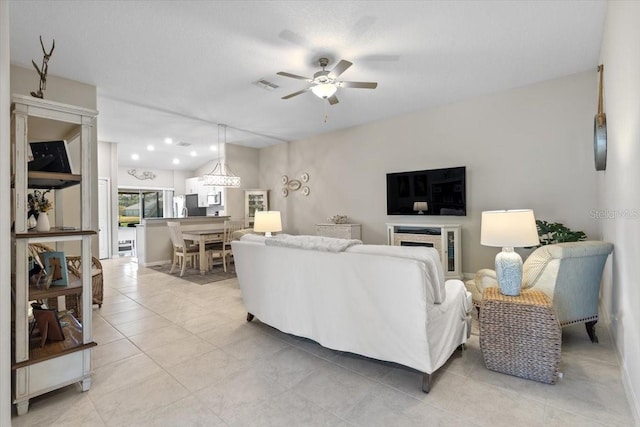 tiled living room with ceiling fan