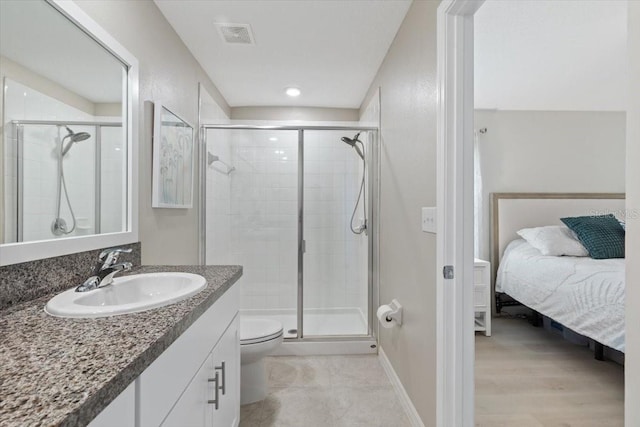 bathroom featuring a shower with door, vanity, wood-type flooring, and toilet