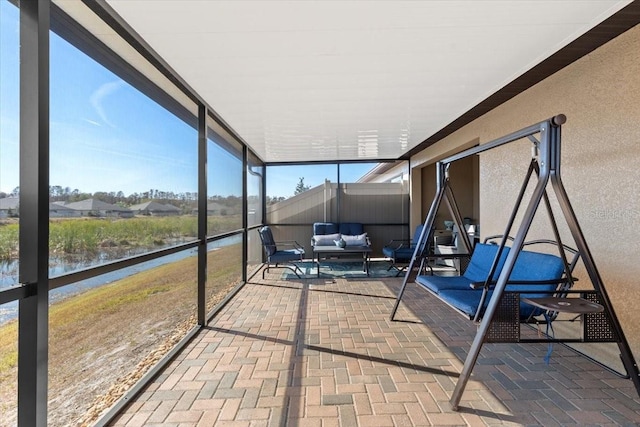 sunroom / solarium with a water view