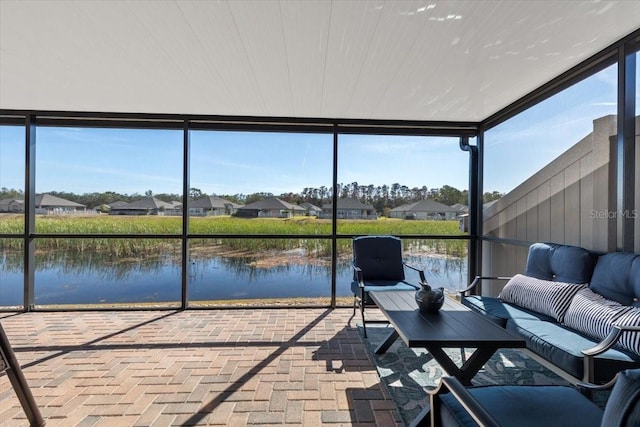 unfurnished sunroom with a water view and a healthy amount of sunlight