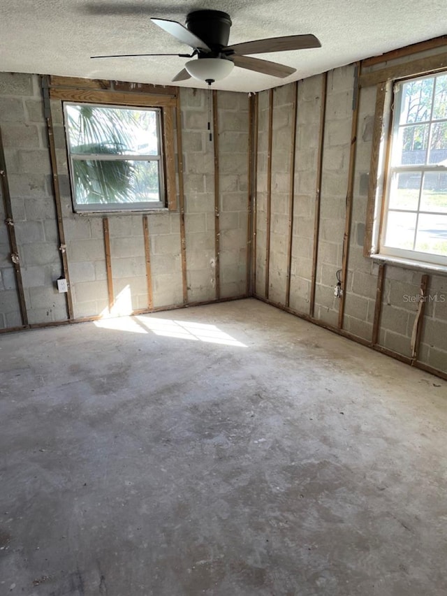 interior space with concrete flooring, a healthy amount of sunlight, and a textured ceiling