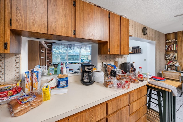 kitchen with light tile patterned floors and a textured ceiling