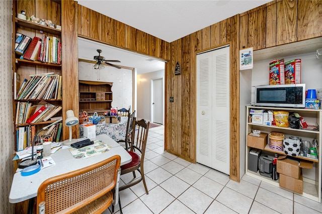 tiled office with ceiling fan and wood walls