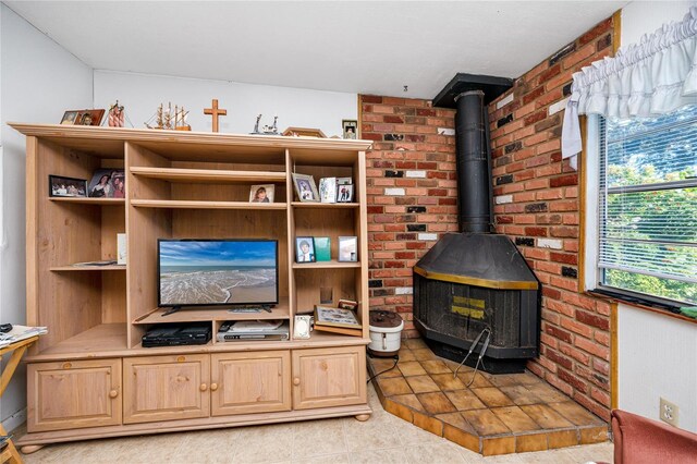 living room with light tile patterned floors and a wood stove