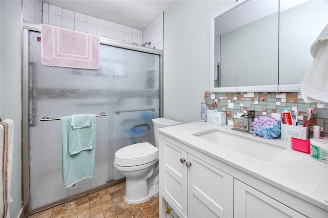 bathroom with tasteful backsplash, walk in shower, a textured ceiling, vanity, and toilet