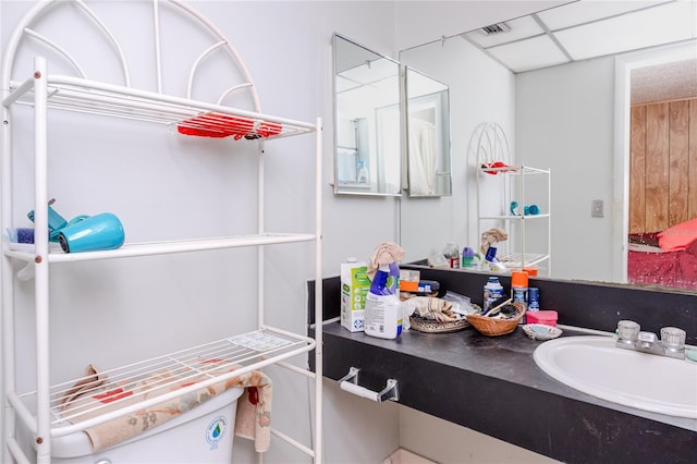 bathroom with vanity, a paneled ceiling, and toilet