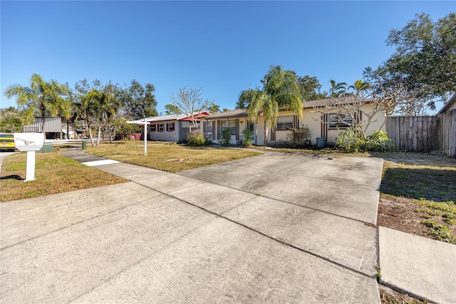 ranch-style home with a front lawn