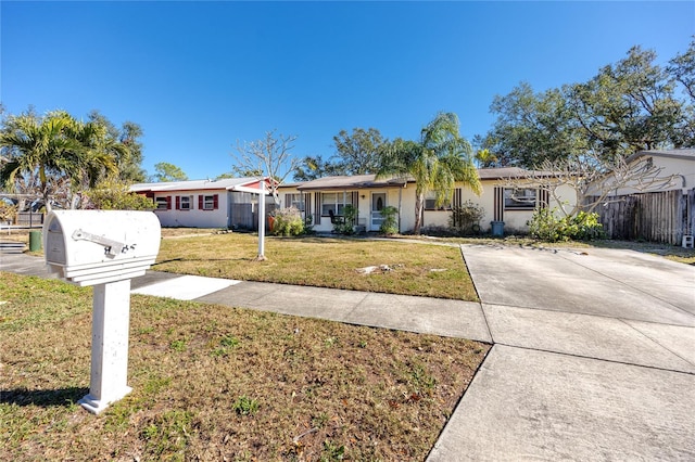 ranch-style home with a front lawn