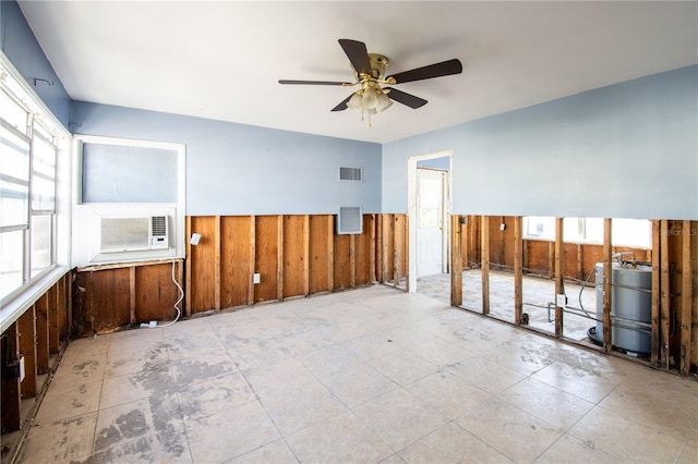 empty room with cooling unit, ceiling fan, and wooden walls