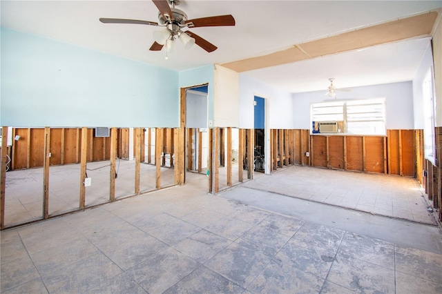 empty room with ceiling fan, cooling unit, and wooden walls