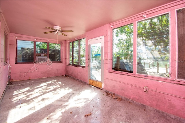 unfurnished sunroom with a wealth of natural light, cooling unit, and ceiling fan