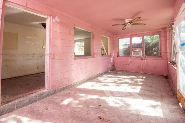 unfurnished sunroom featuring ceiling fan