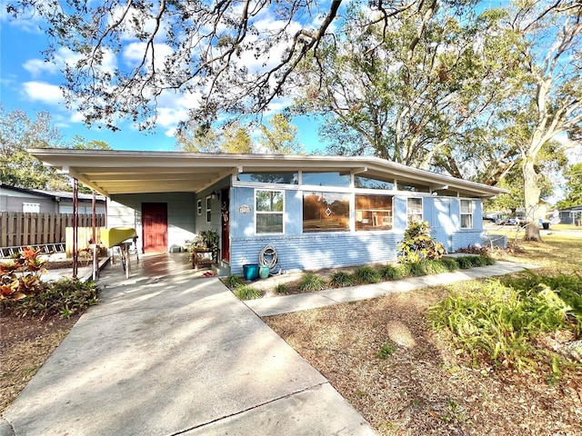 ranch-style home featuring a carport