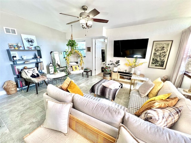 living room featuring ceiling fan and a healthy amount of sunlight