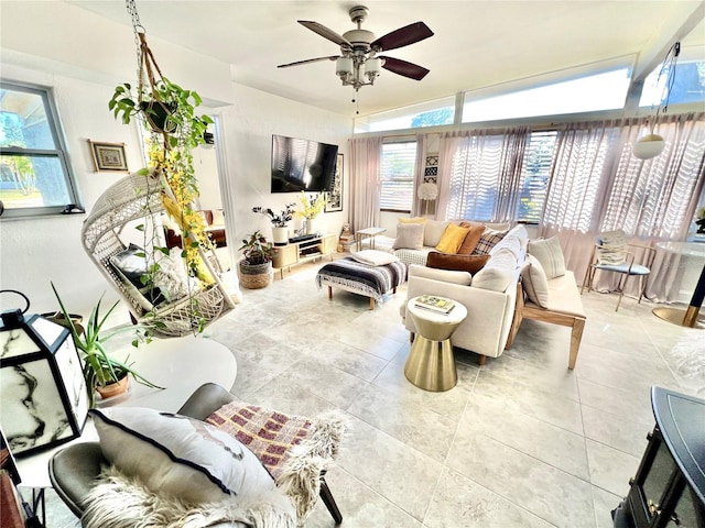 living room featuring ceiling fan, plenty of natural light, and vaulted ceiling