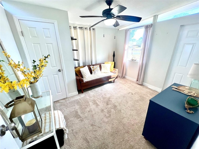 carpeted living room with ceiling fan