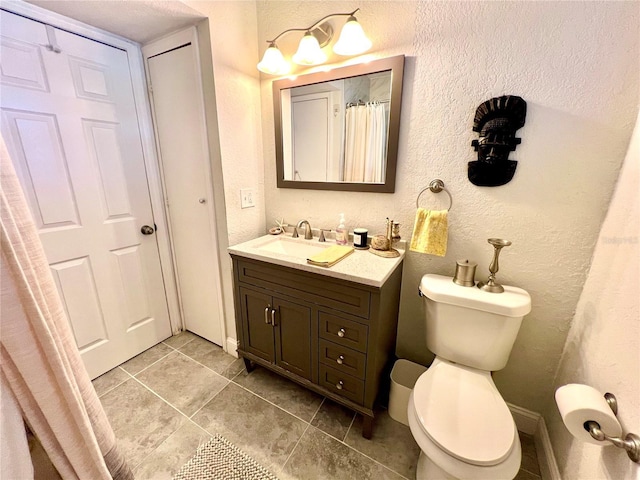 bathroom with tile patterned floors, vanity, and toilet