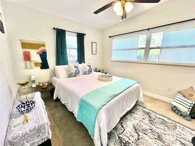 carpeted bedroom featuring vaulted ceiling and ceiling fan