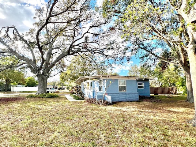 view of property exterior featuring a lawn