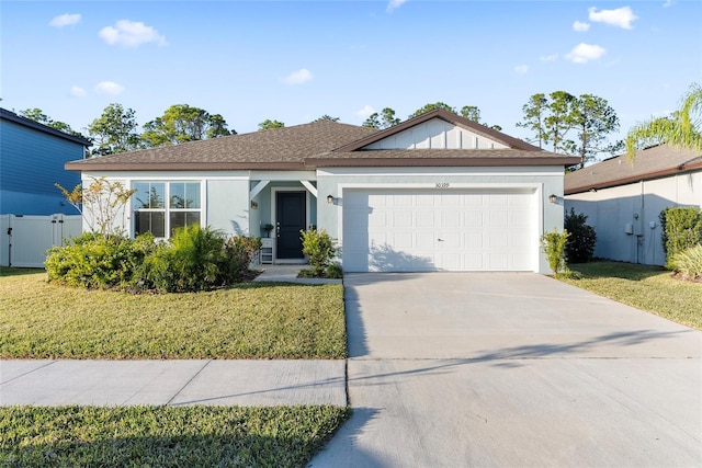 view of front of house with a front yard and a garage