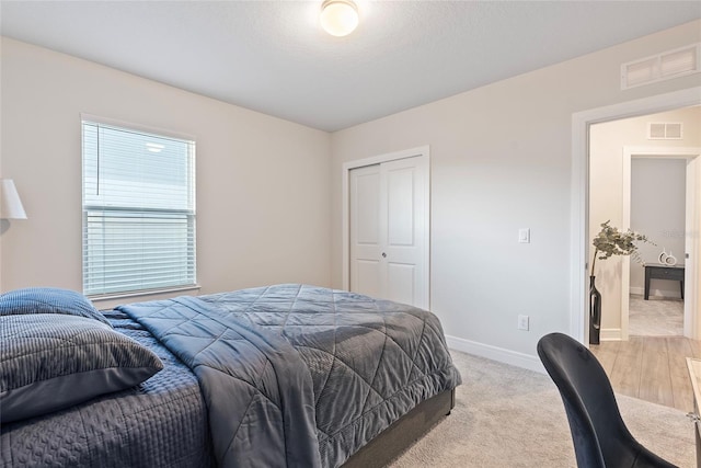 bedroom featuring light hardwood / wood-style floors and a closet