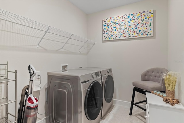 clothes washing area featuring separate washer and dryer