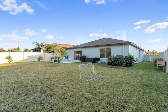 rear view of property with a patio area and a yard