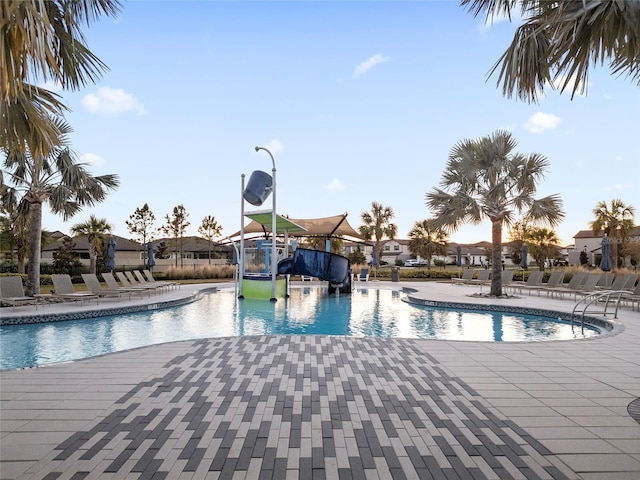 view of pool featuring a patio and a water slide