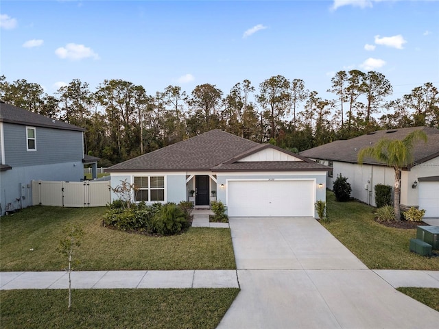 ranch-style house featuring a front yard and a garage