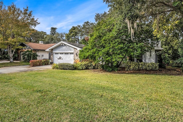 view of front facade with a front yard and a garage